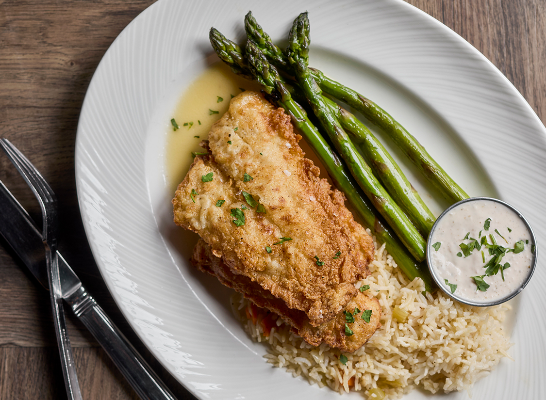 a plate of food with asparagus and rice
